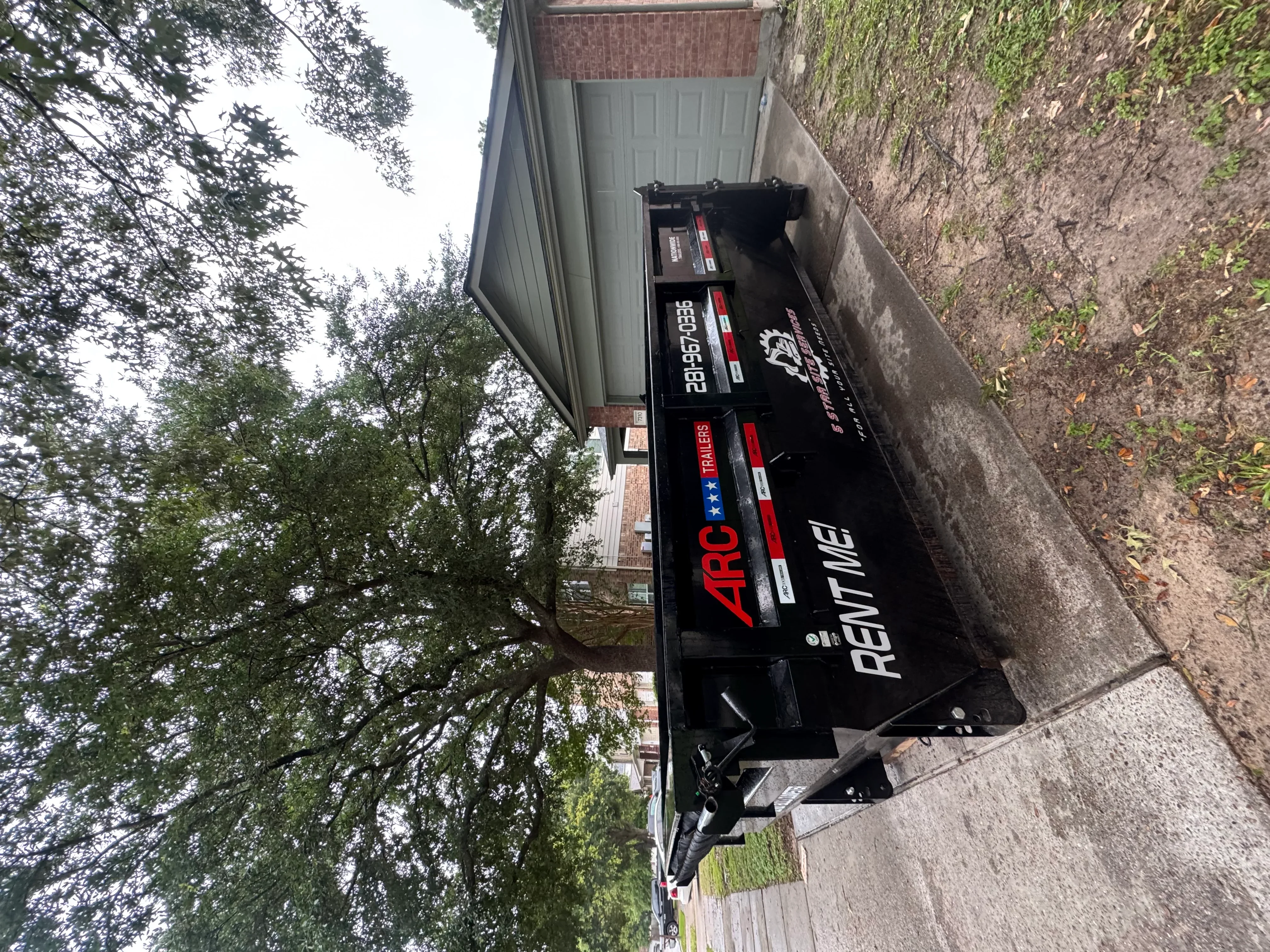 Black ARC refrigerator unit loaded on trailer for removal and hauling